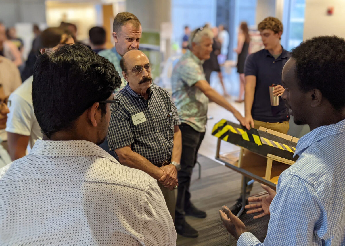 Spectators get an explanation of a project at Capstone