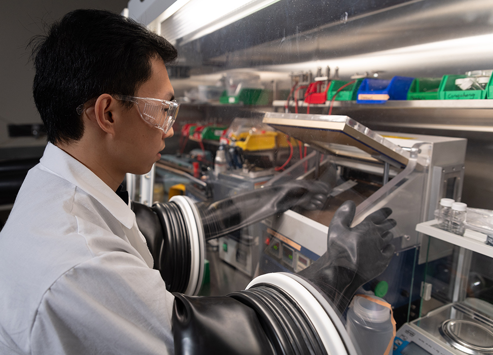 Postdoctoral researcher Dr. Congcheng Wang builds a battery cell.