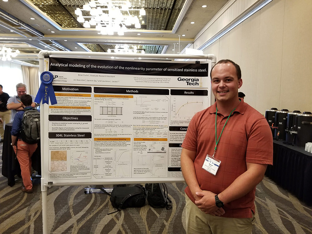 Brian Fuchs in front of his prize-winning poster Brian Fuchs in front of his prize-winning poster