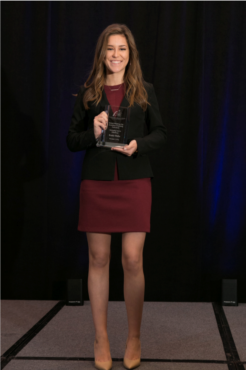 Brooke Waller holding her philanthropy award