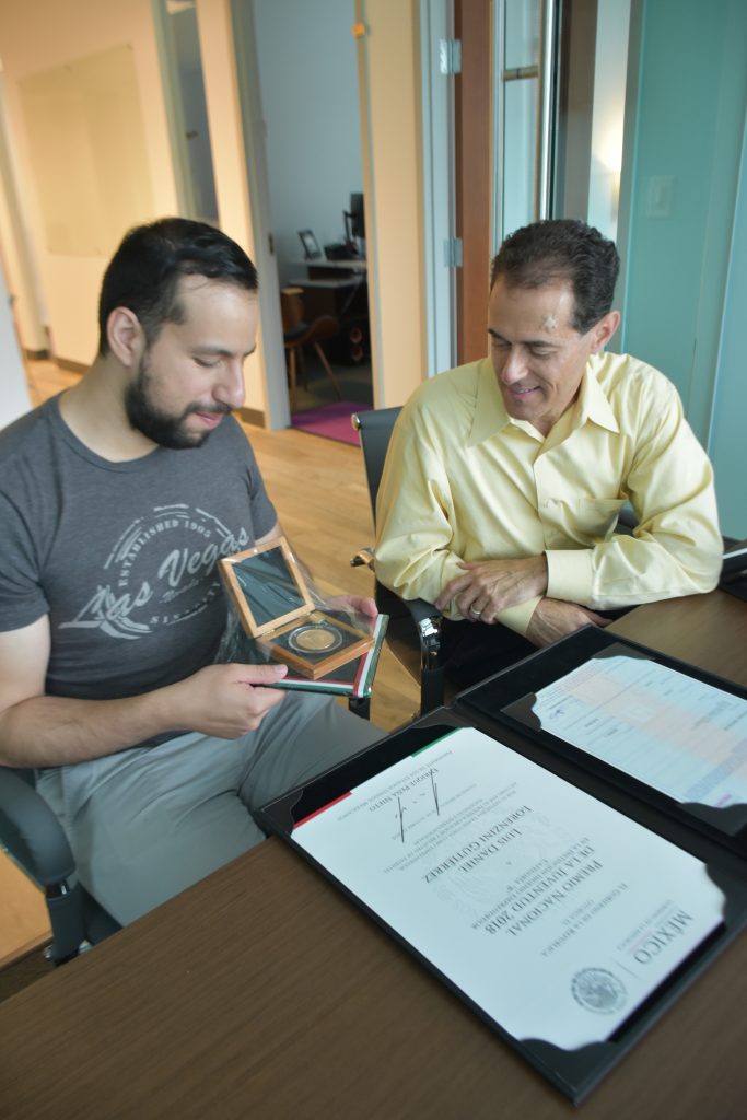 Daniel Lorenzini (left), founder of EMCOOL, shows Jonathan Goldman, a principal in Georgia Tech’s VentureLab program, his entrepreneurship award he received from the Mexican government for his work in co-founding a startup in that country