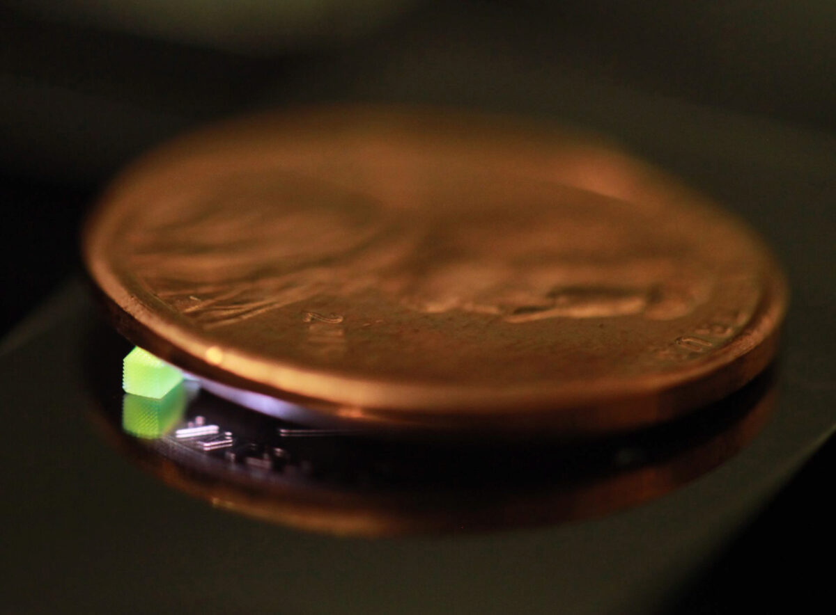 A millimeter-scale structure with submicron features is supported on a U.S. penny on top of a reflective surface. (Credit: Vu Nguyen and Sourabh Saha) A millimeter-scale structure with submicron features is supported on a U.S. penny on top of a reflective surface. (Credit: Vu Nguyen and Sourabh Saha)