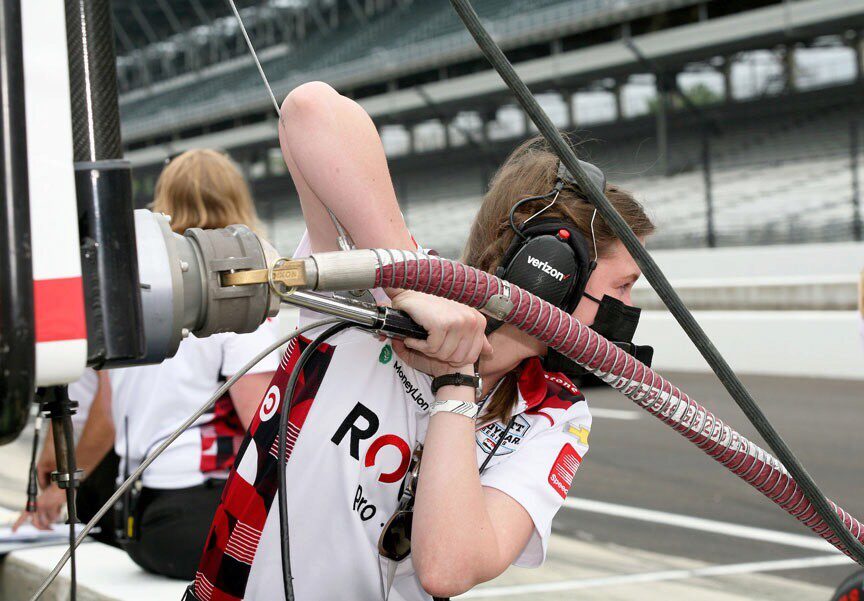 Chelsea fueling the team car, one of her many duties.