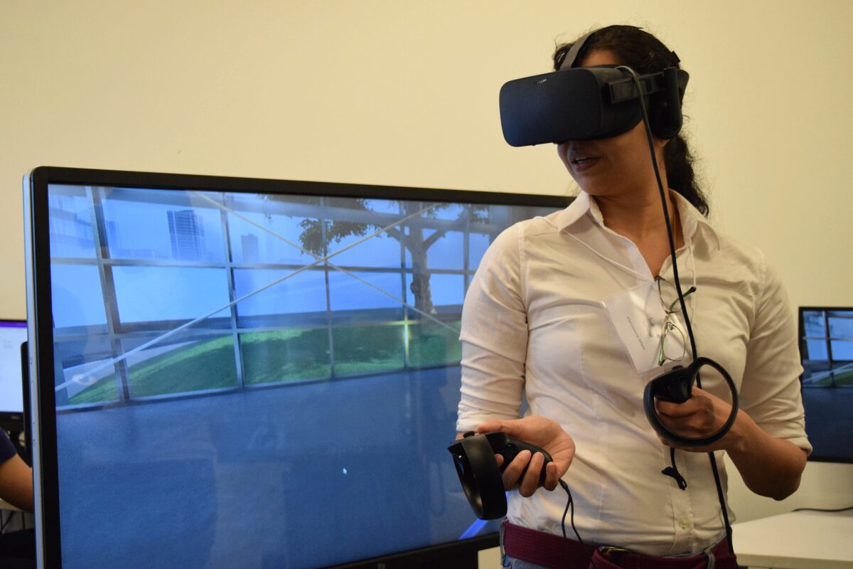 Woman with interactive goggles in front of testing screen Woman with interactive goggles in front of testing screen