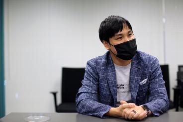 Hong Yeo seated at a conference room table