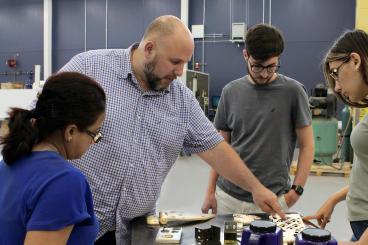 Aaron Stebner (second from left), associate professor in the College of Engineering, leads a lab session with students in the Delta Air Lines Advanced Manufacturing Pilot Facility at Georgia Tech. (Photo: Christa M. Ernst)