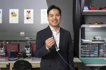 Hong Yeo holds an in-stent nanomembrane sensor that can detect intracranial pressure.