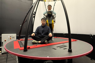 Yipu Chen (seated) and Zhaoyuan Gu (standing) on the CAREN treadmill system