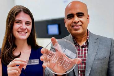 Ankur Singh will lead Georgia Tech’s new ETHOS initiative to advance New Approach Methodologies (NAMs) and transform drug discovery through human-relevant systems. Singh is pictured alongside Ph.D. student Olivia Jones, holding a human immune organ engineered on-a-chip, a breakthrough innovation developed at Georgia Tech to model complex immune responses outside the body.