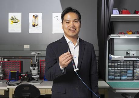 Hong Yeo holds an in-stent nanomembrane sensor that can detect intracranial pressure.